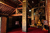 Wat Xieng Thong temple in Luang Prabang, Laos. The sim s interior is extensively decorated with intricate gold stencilling on black lacquer. Large stencilled teak wood pillars support the roof.  